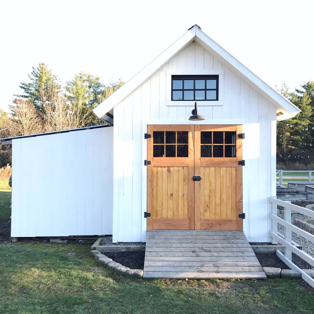 White garden shed with wooden doors
