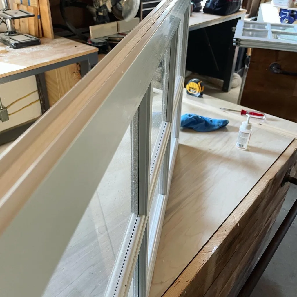 Added wood for sturdiness in vinyl window