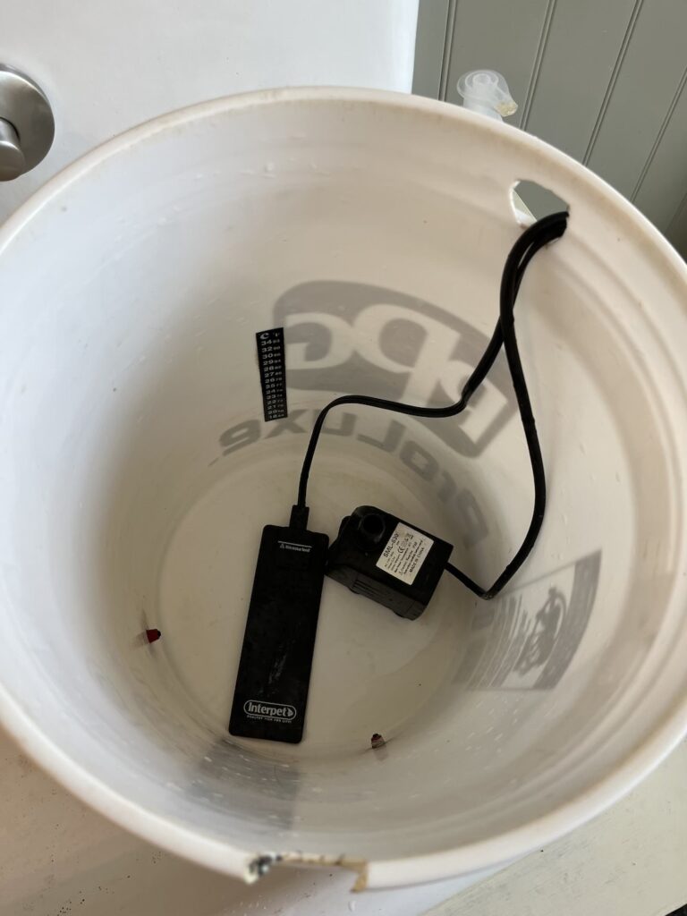 Heater and bubbler in a five gallon bucket for heated chicken waterer