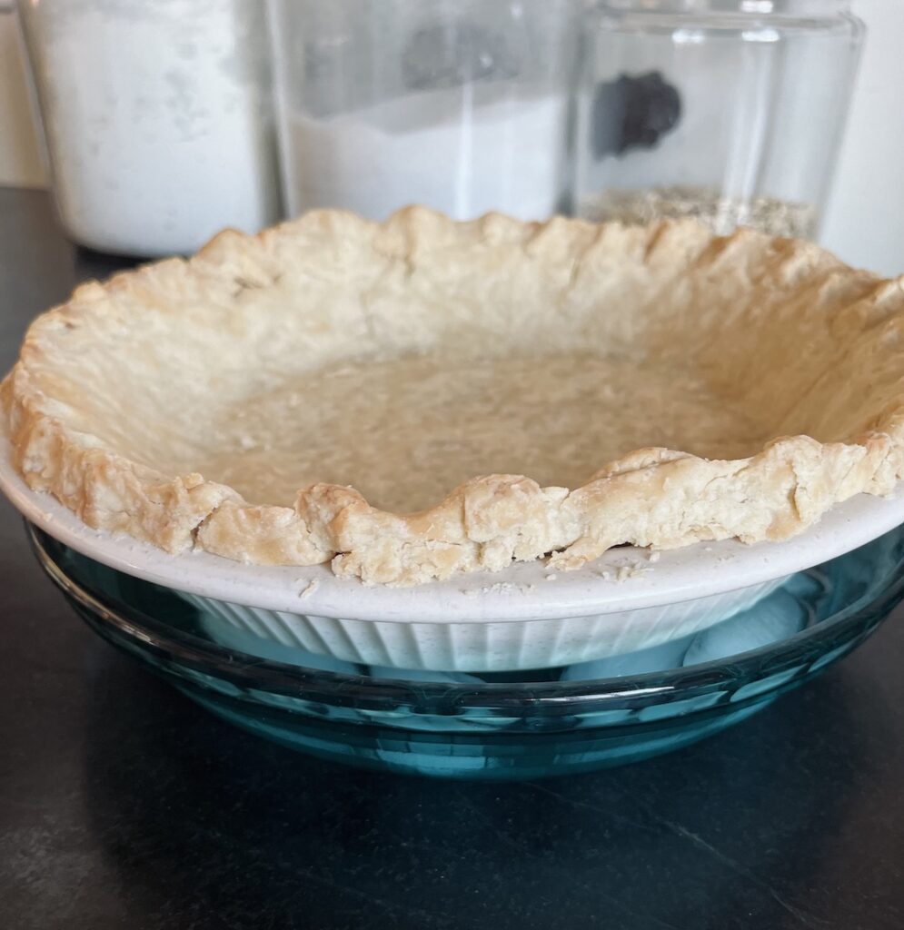 Pie crust cooling in a pie pan of ice to get ready for filling