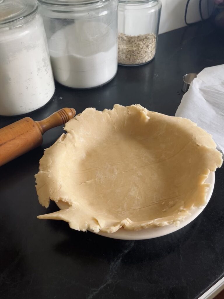 Pie crust flopped into pan before trimming and crimping