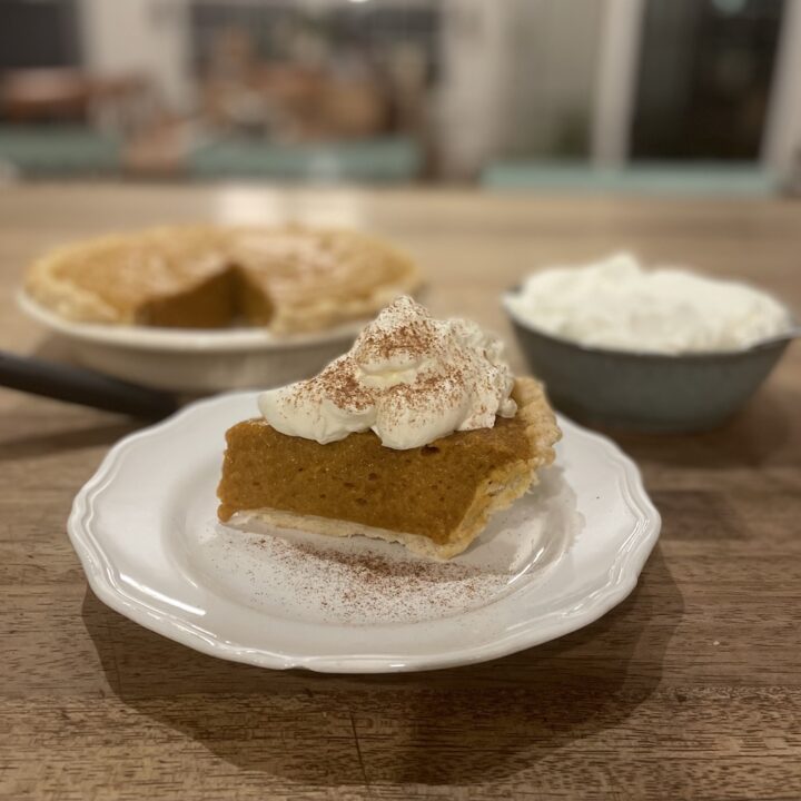 Pumpkin Chiffon Pie with whipped cream and cinnamon