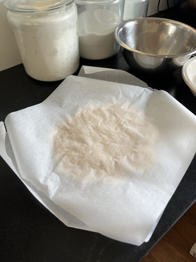 Pie dough sandwiched between two sheets of parchment paper
