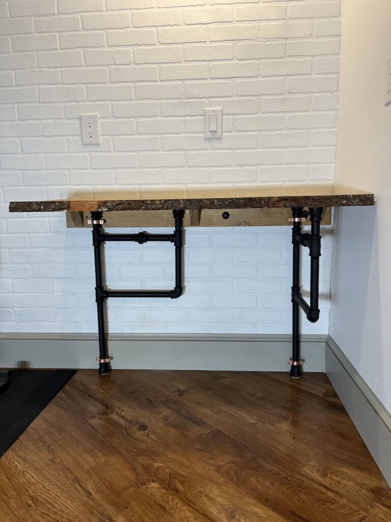 Folding wall desk with one leg turned in
