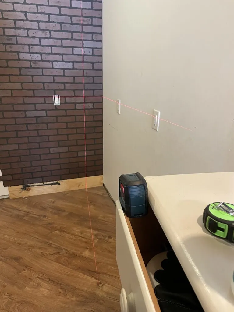Using a laser level to level faux brick sheets