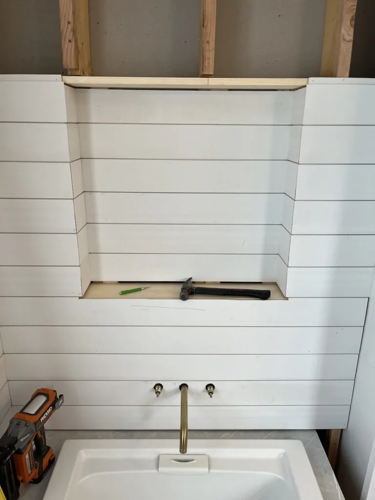 Shiplapped recessed for shelves in tub alcove