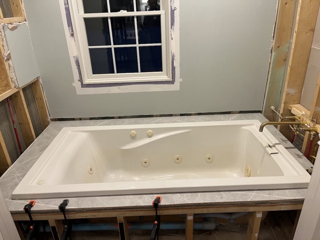 Clamped new laminate over tile bathtub deck