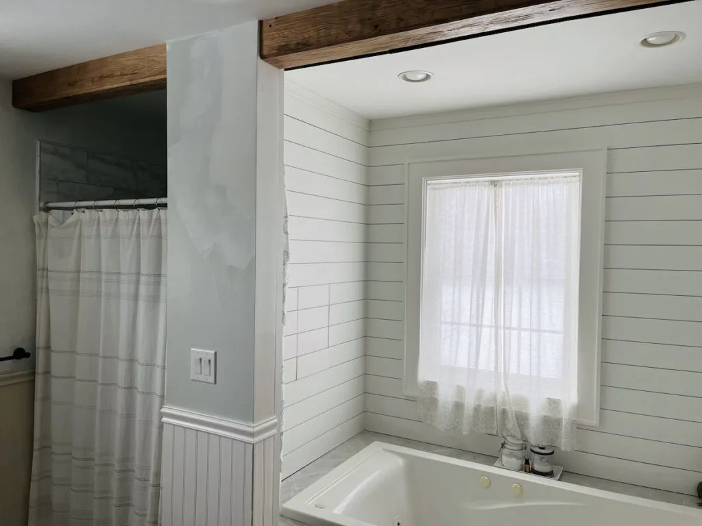 Wood beam betwen tub and shower area