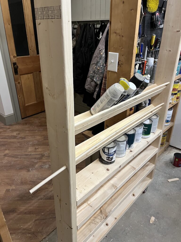 Dowel rail for spray paint shelves