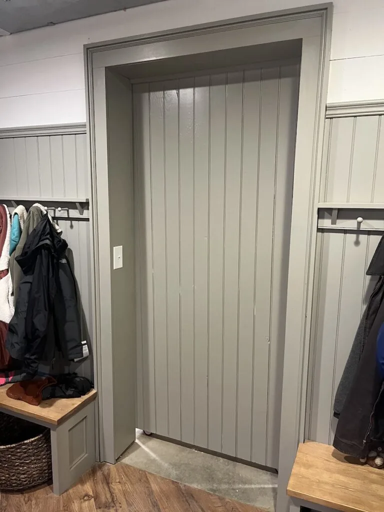 Hidden door from inside the mudroom, office and workout space