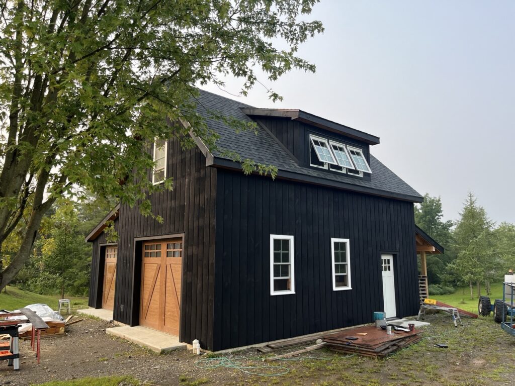 Black barn style garage nearly complete