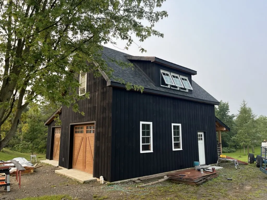 Black barn style garage nearly complete